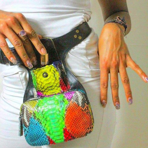 Black leather strap bag with colourful front zip pockets